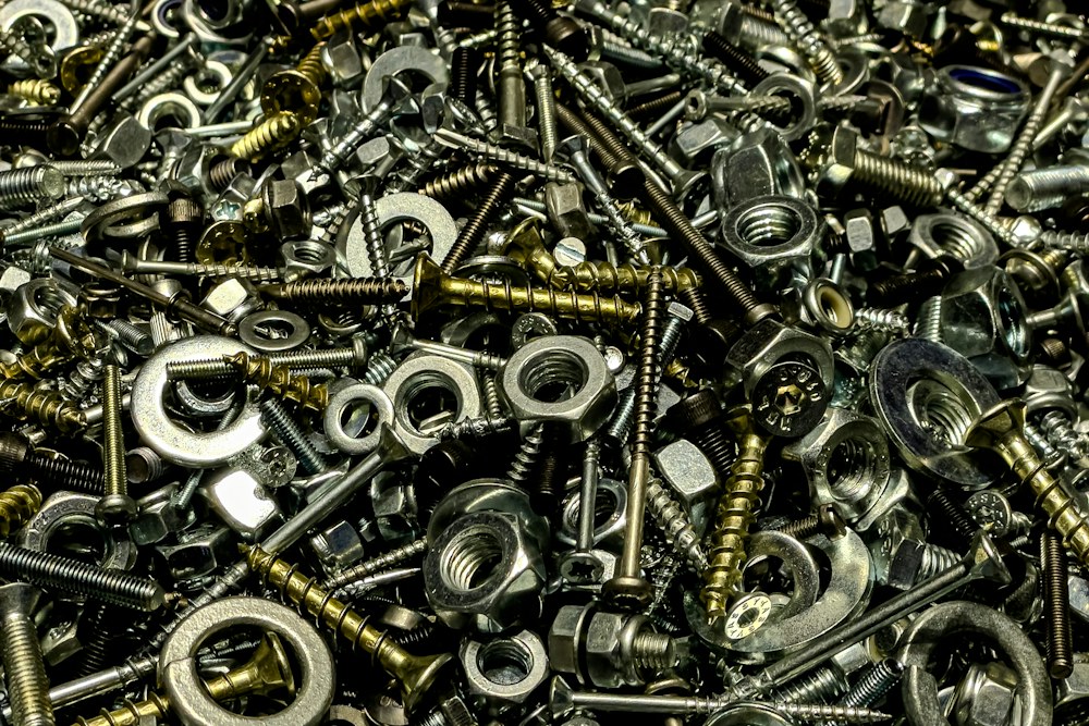 A large pile of assorted nuts, bolts, and washers; illustrative stock photograph