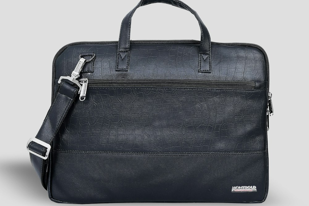 A dark blue briefcase with a shoulder strap; illustrative stock photograph