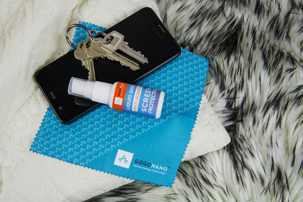 Phone, keys, screen protector, and cleaning cloth; illustrative stock photograph
