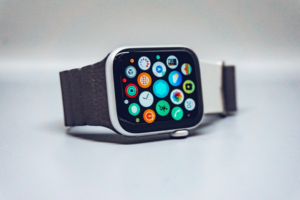 A smartwatch with a dark textured band and a colorful app icon display; illustrative stock photograph
