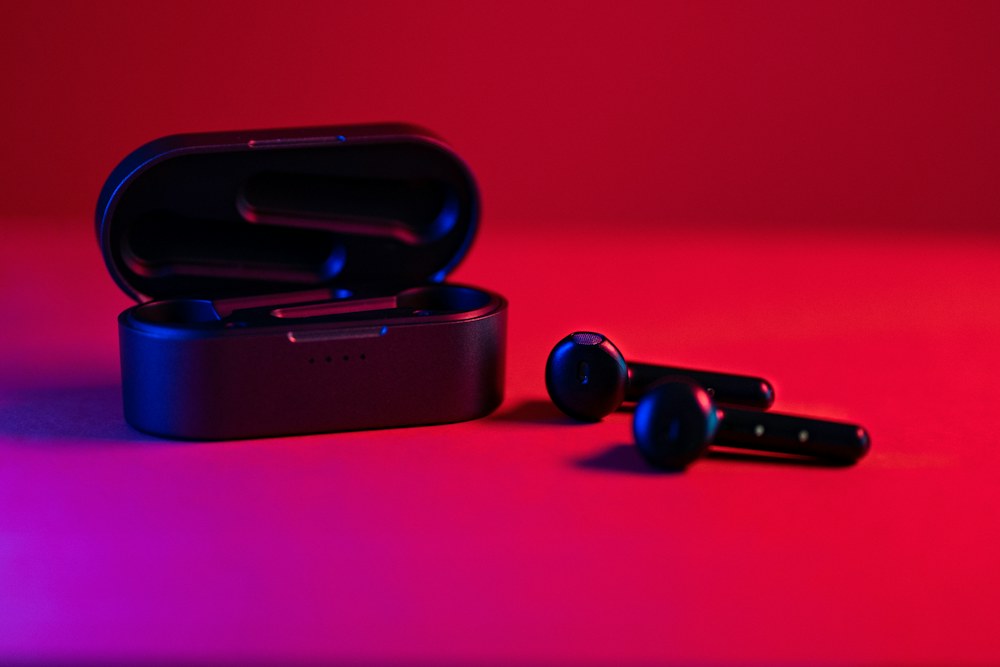 black and blue bluetooth earbuds; illustrative stock photograph